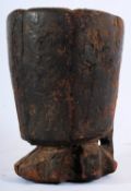 A 19th  tribal art hardwood beaker of rustic form having terraced base, unusual arch to side with