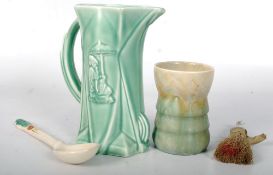 A 1930`s Delcroft jug together with a porcelain crinoline lady crumb brush, a china 1930`s Art Deco