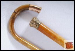 A Malacca walking cane with polished brass knop and a bamboo walking stick with a polished copper