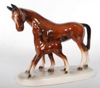 A decorative continental porcelain horse and fowl figurine, marked GDR to the underside.