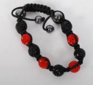 A Shambala bracelet with red and black beaded design