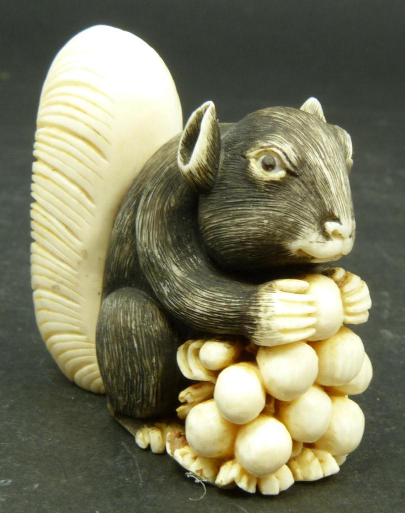 JAPANESE CARVED IVORY SQUIRREL NETSUKEJapanese carved ivory netsuke figure depicting a squirrel with