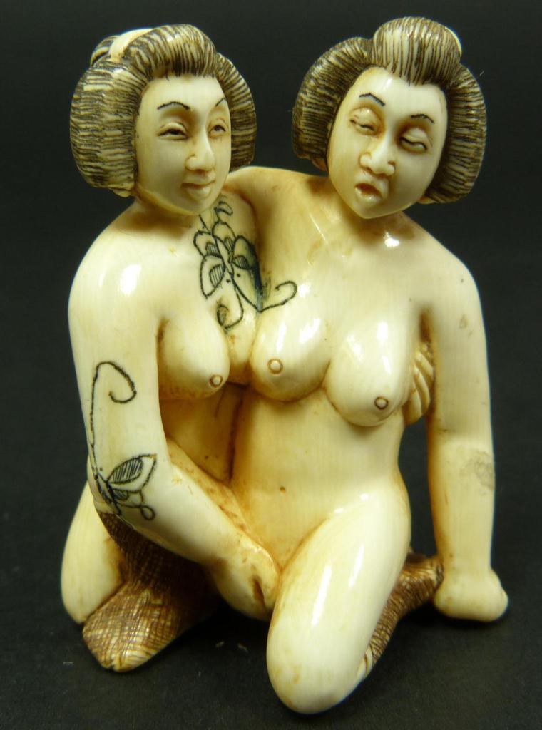 CARVED IVORY EROTIC NETSUKE OF 2 WOMEN, SIGNEDHand carved Japanese polychromed ivory erotic