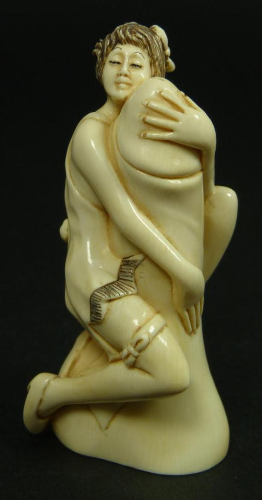 CARVED IVORY EROTIC NETSUKE OF WOMAN, SIGNEDHand carved Japanese ivory erotic netsuke depicting a