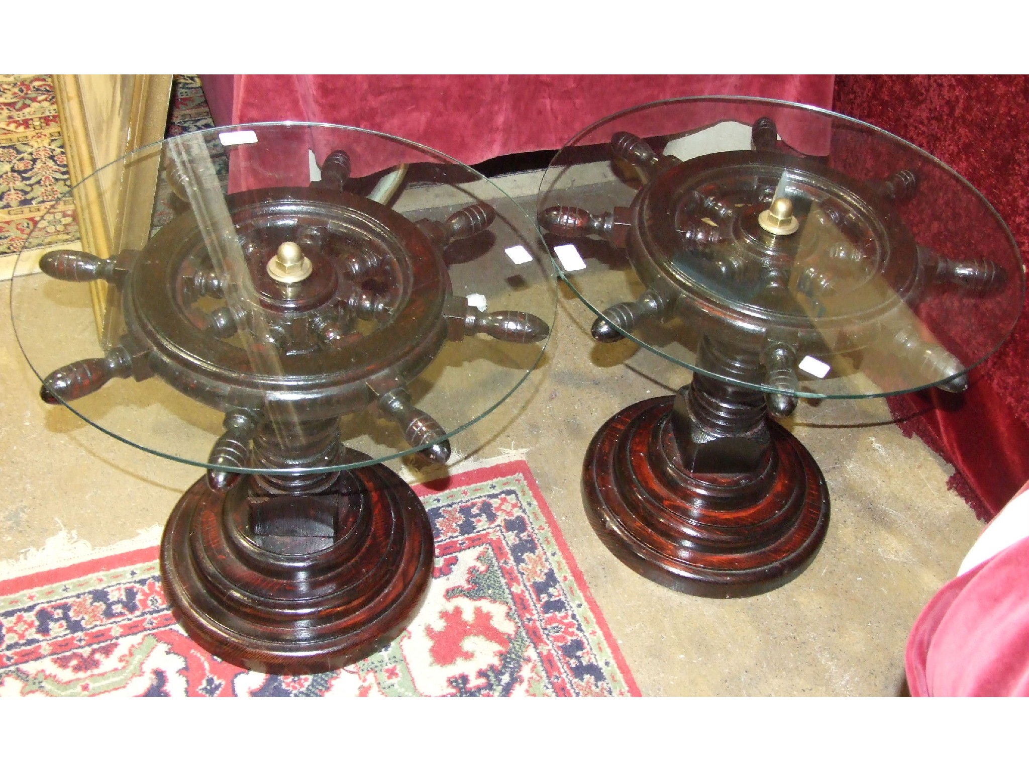 A pair of modern stained wood occasional tables, the top in the form of an eight-spoke ships