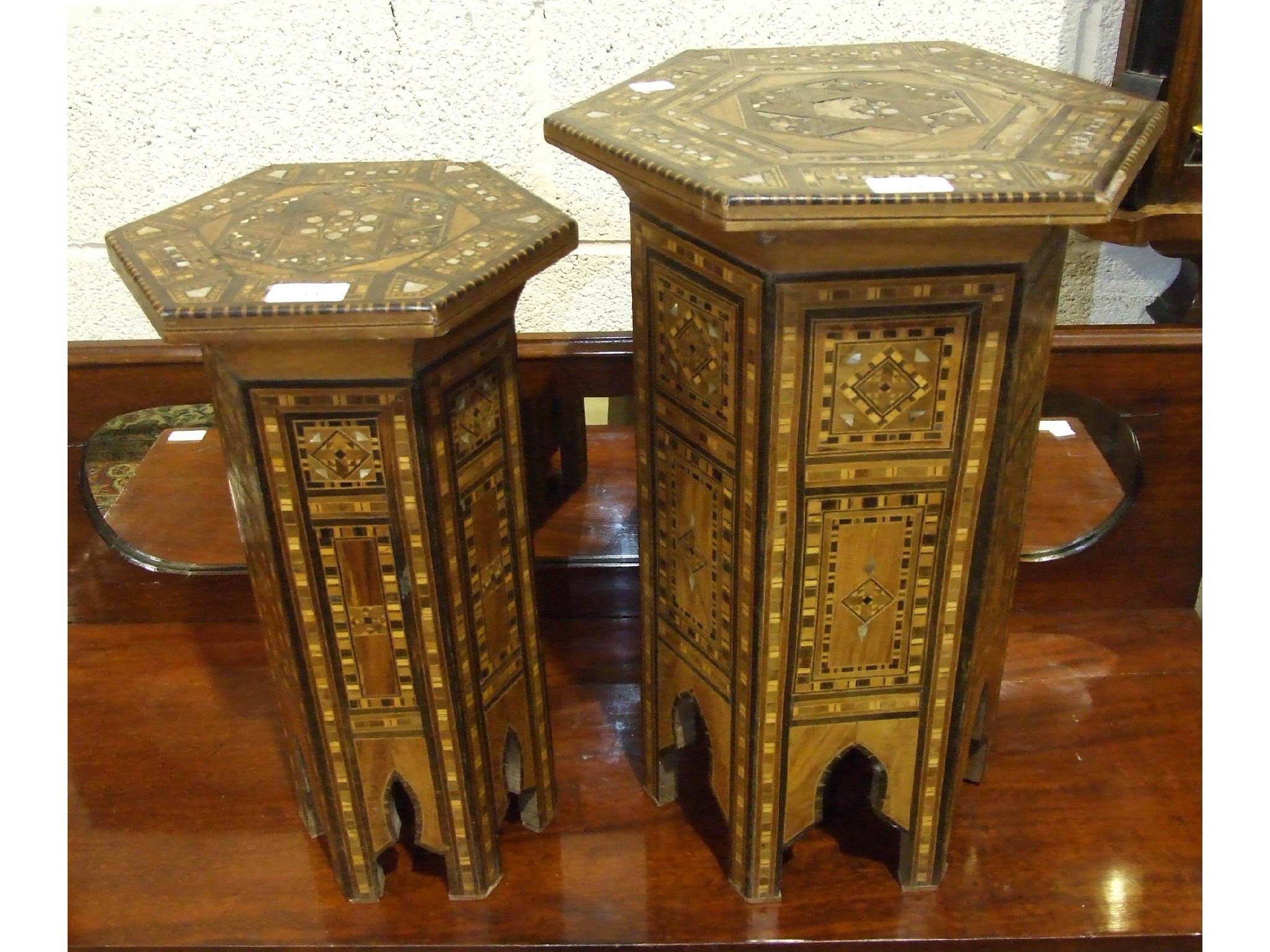 An Eastern hexagonal plant stand with marquetry and mother of pearl inlay overall, 35cm wide, 52cm