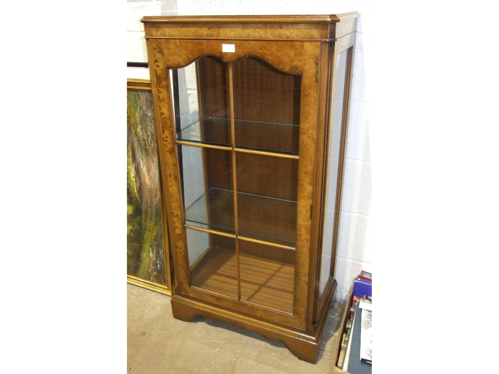 A burr walnut display cabinet fitted with a single glazed door, 61cm wide, 122cm high.