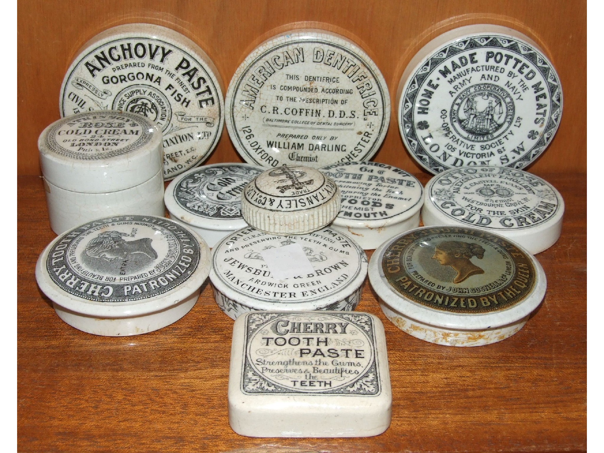 A collection of eleven various late-19th century pot lids for toothpaste, cold cream, meat paste,