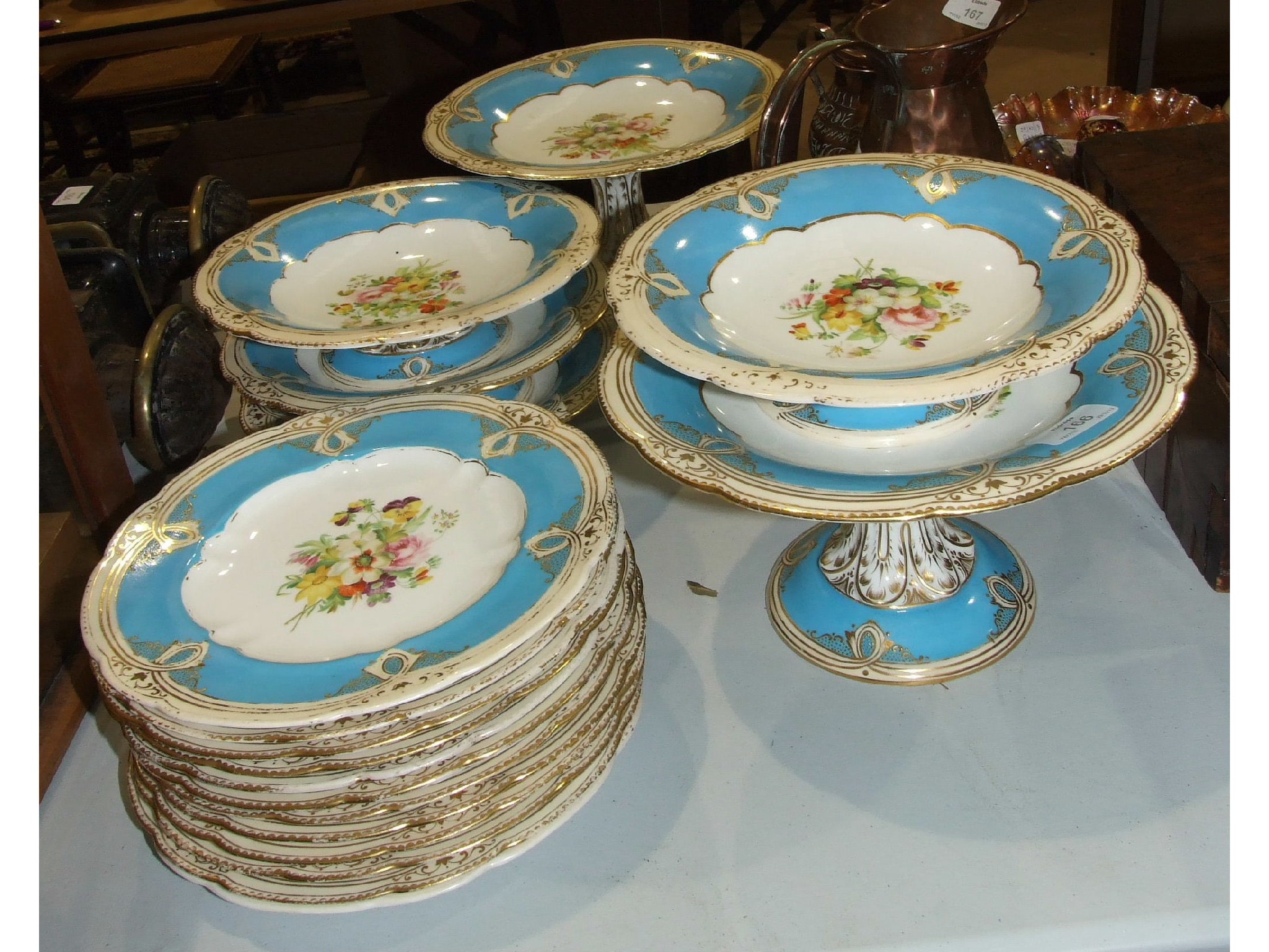 Eighteen pieces of a late-19th century dessert service with central floral decoration and a blue and