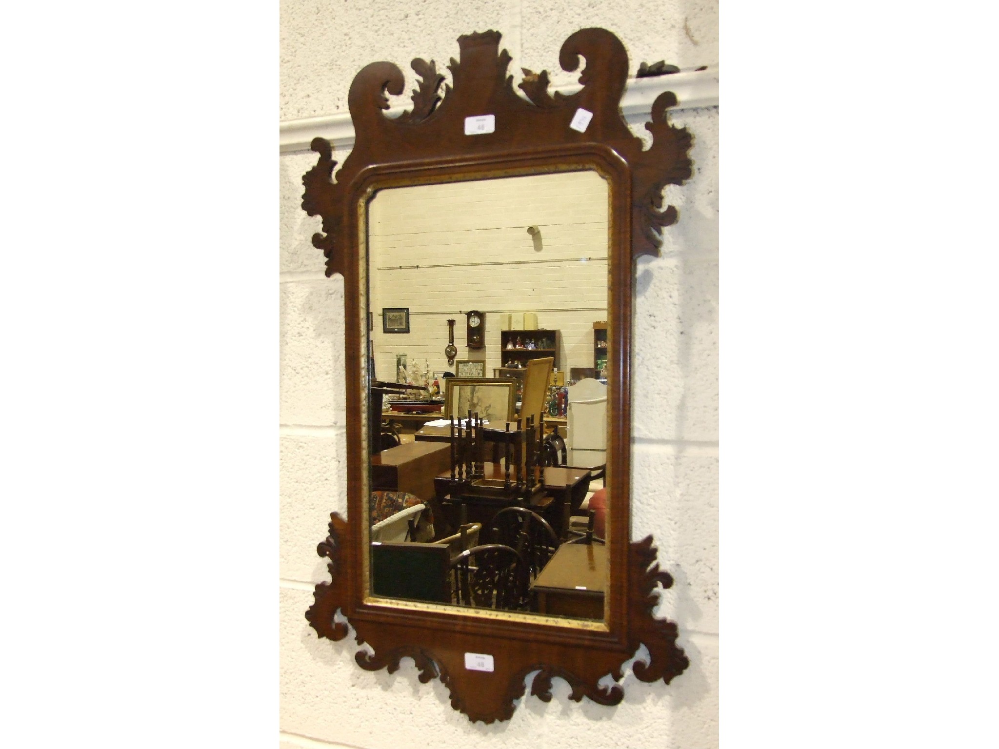 A Georgian-style mahogany parcel gilt wall mirror, 51 x 92cm.