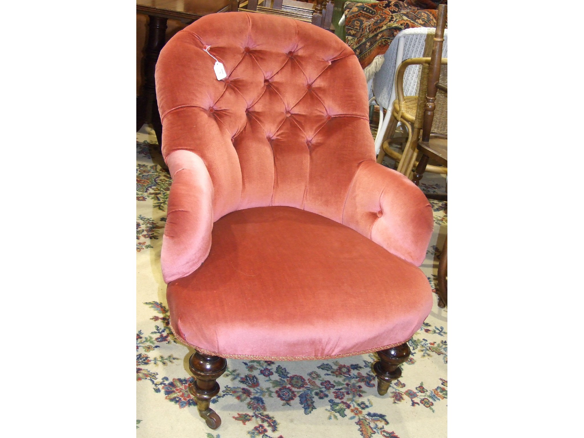 A late-19th/early-20th century upholstered button-back nursing chair on short turned stained wood