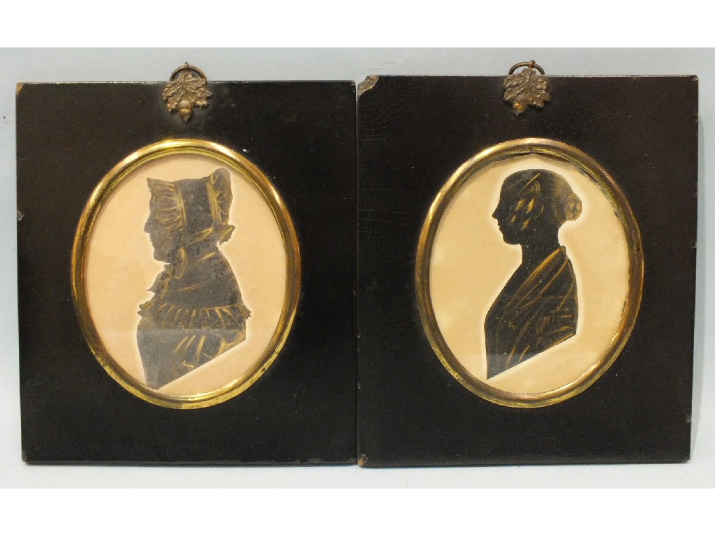 Two Victorian silhouettes, one of a young woman, the other a mature woman wearing a bonnet, both