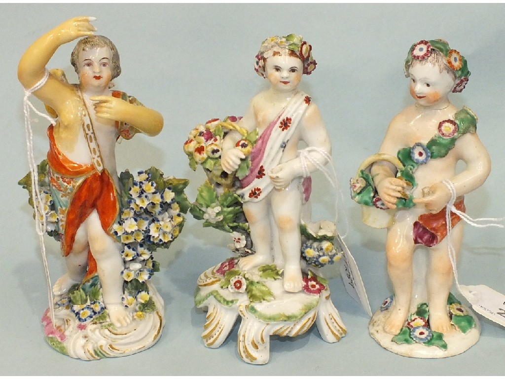 Three late-18th century English porcelain figures of standing cherub gardeners, 14cm, (3).