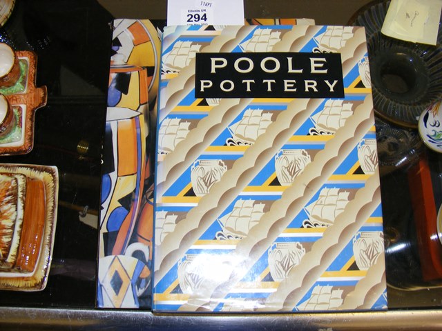 A Poole Pottery book together with a Clarice Cliff hardbacked reference books