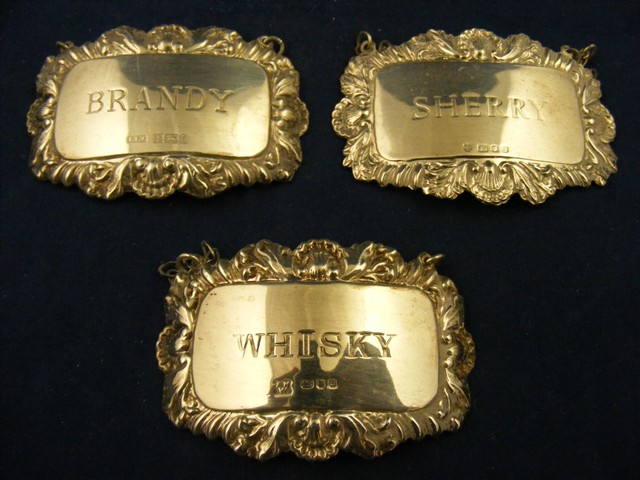Three silver decanter labels to include Whisky, Sherry and Brandy est.