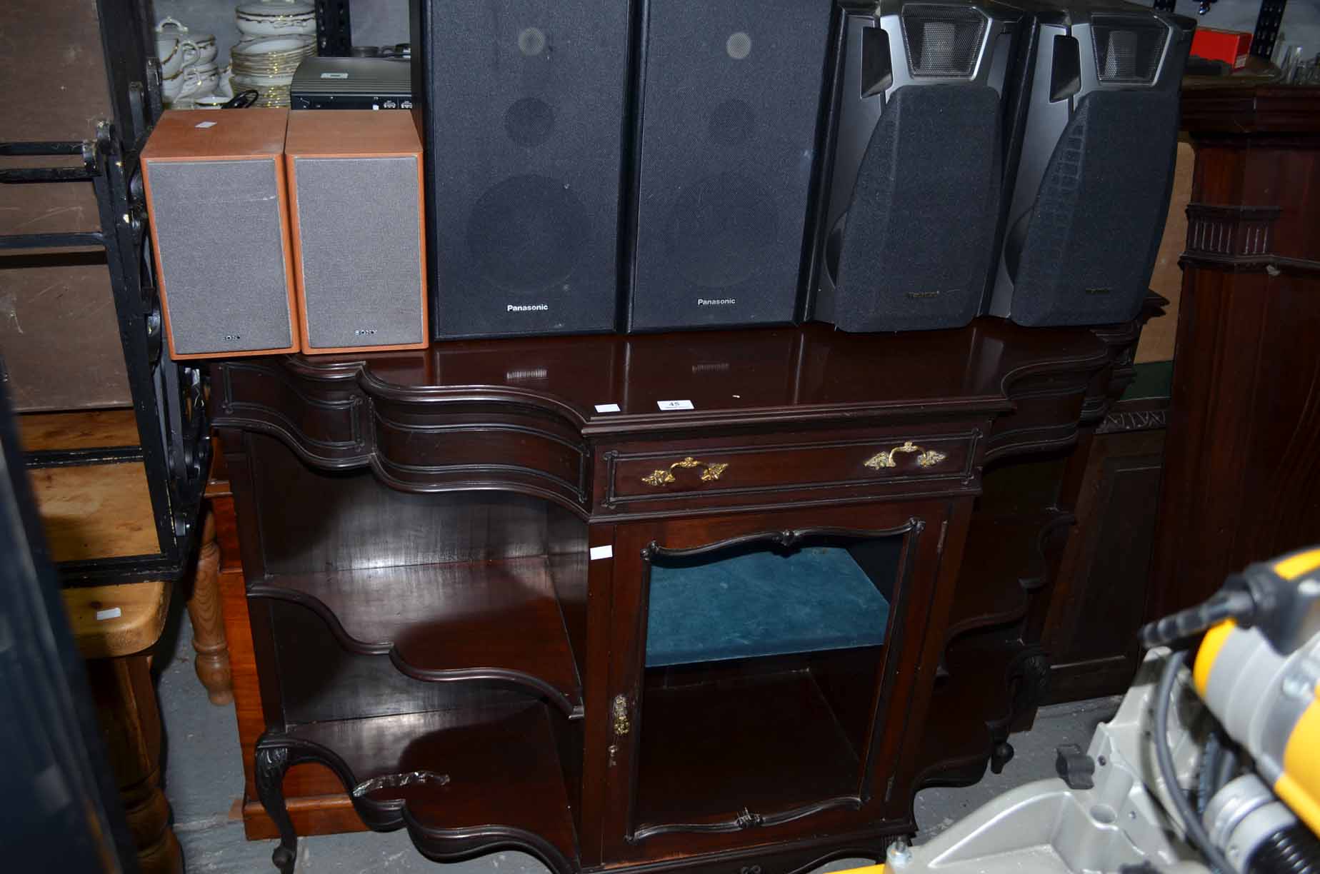 Mahogany serpentine sideboard with glazed doors and gallery shelving