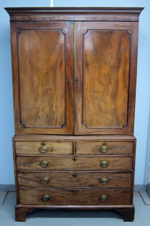 19th century mahogany linen press made by W. Williamson & Sons of Guildford, the top with two