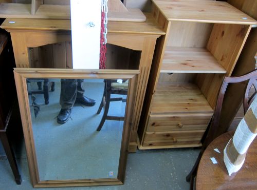 Three pine bookcases and a mirror,