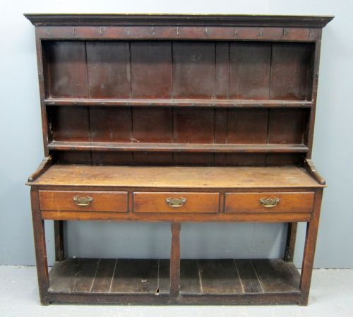 18th century oak dresser, with three tier plate rack on base with three drawers above an open