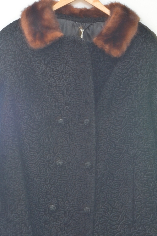 A vintage ladies astrakhan fur coat with fur trim collar and decorative brown buttons, approximate