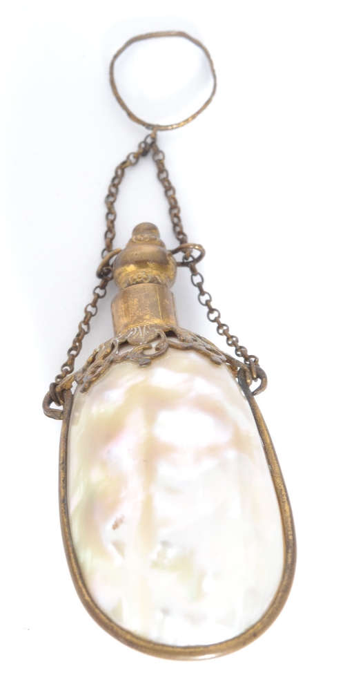 An early 20th Century mother of pearl scent bottle with gilt mounts and pierced collar, length 8cm.