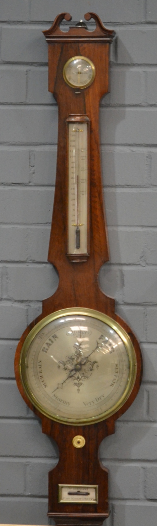 A 19th Century rosewood barometer, silvered register, dry/damp dial and thermometer above lower
