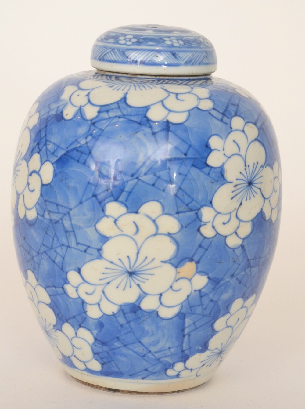 An early 20th Century blue and white Chinese ginger jar and cover decorated with prunus blossom