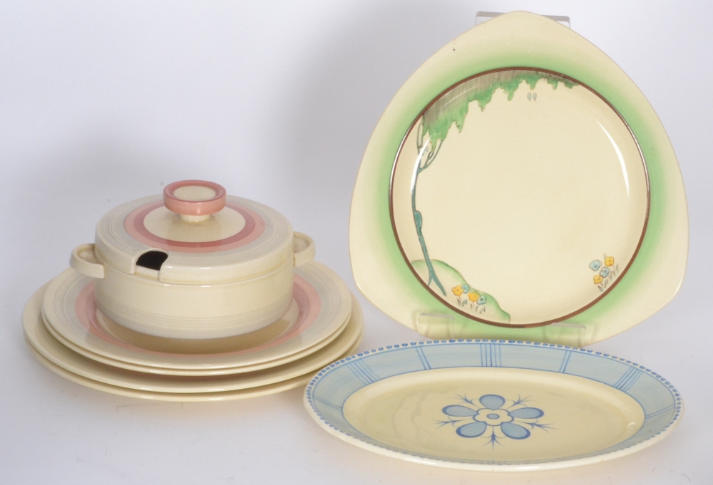 A Clarice Cliff Odilion tureen and cover decorated in a pink banded pattern together with four