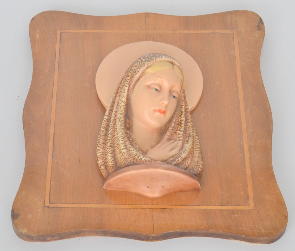 A 1930`s Italian terracotta bust of Madonna with a decorative headscarf and peach halo, impressed