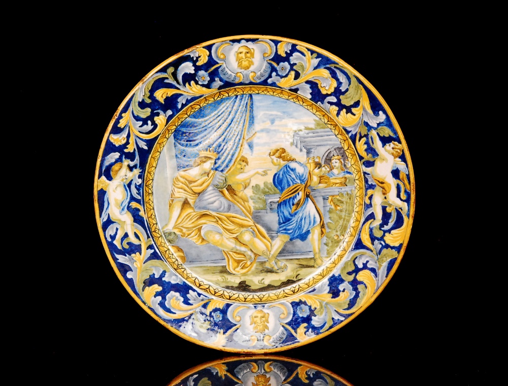 A 19th Century Italian majolica charger decorated in the Deruta style, the central well with a