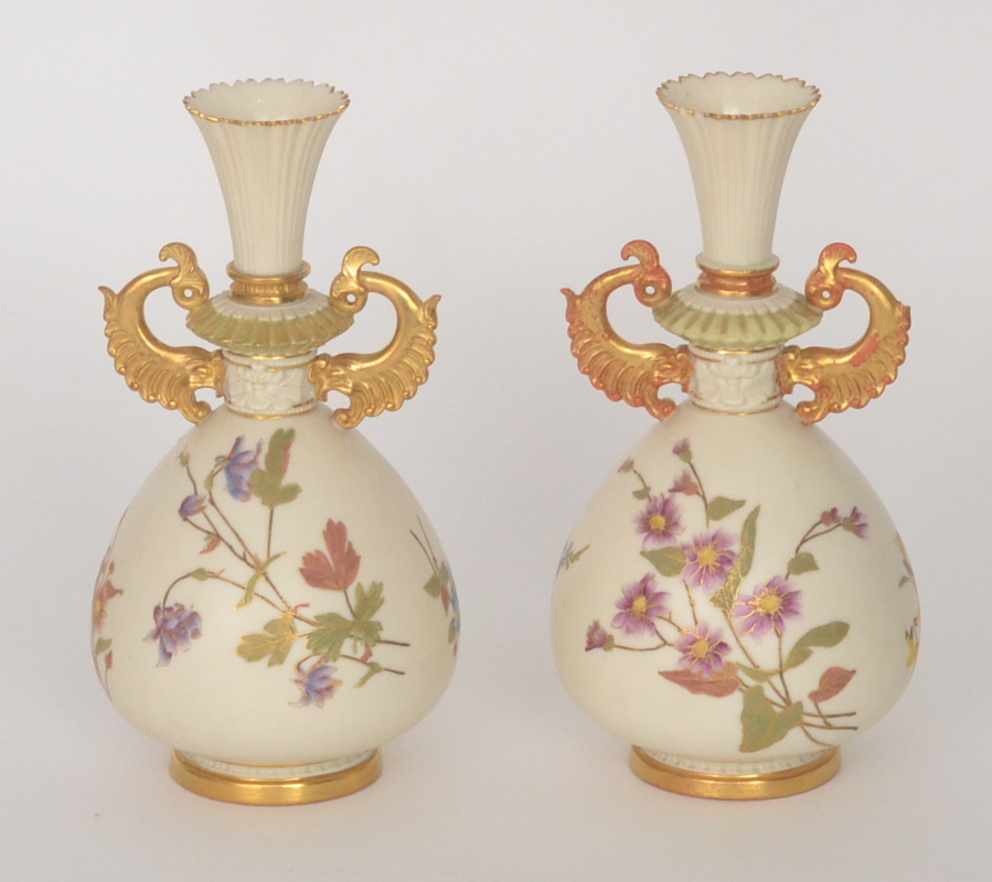 A pair of Royal Worcester blush ivory vases of bulbous form with flared necks, each relief moulded