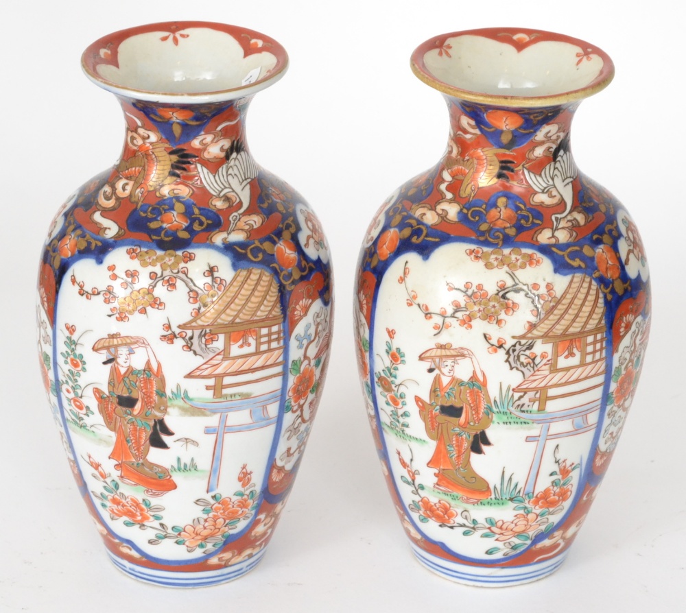 A pair of 20th Century Japanese export baluster vases each decorated in the Imari palette with