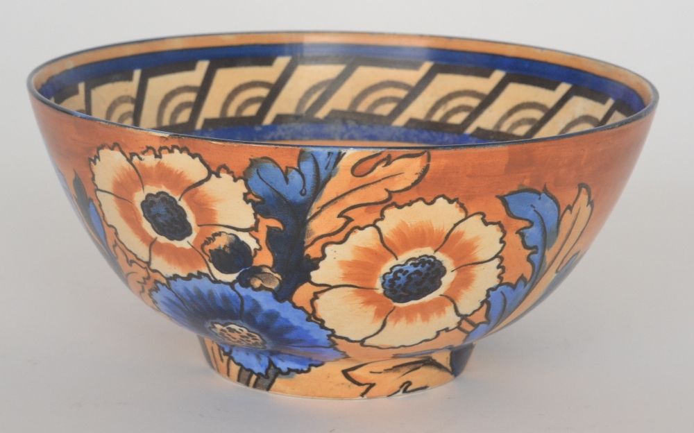 A 1930`s Art Deco Bursley Ware fruit bowl designed by Charlotte Rhead and decorated with orange