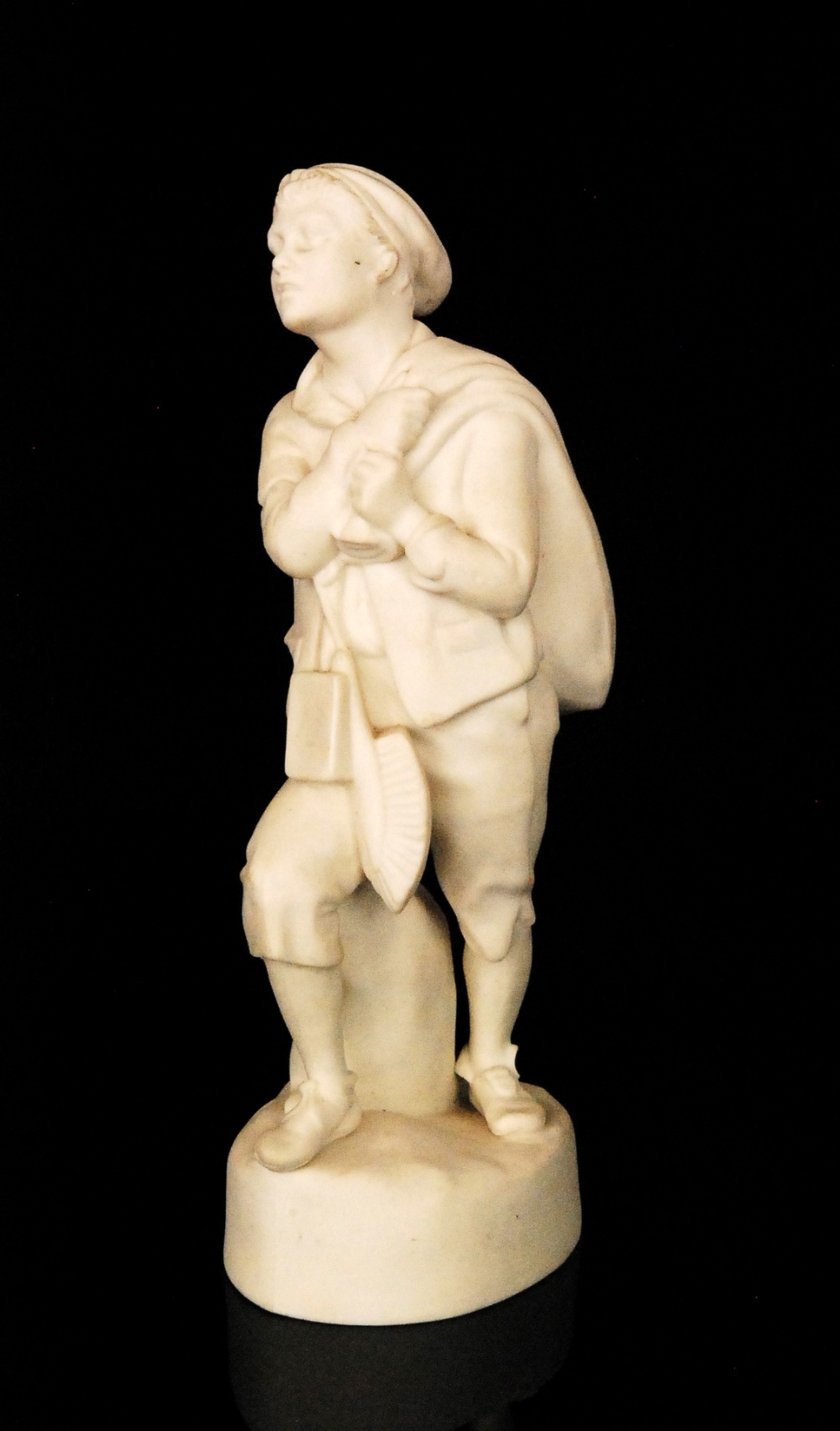 A late 19th Century W.H Goss Parian figure of `The Worker` modelled as a young boy carrying a sack