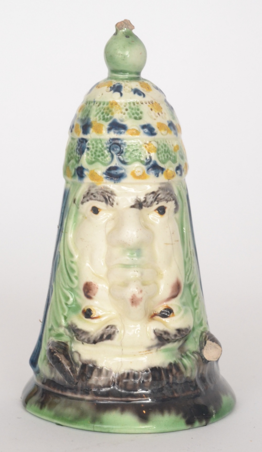 A 19th Century pearlware `Turk and the Devil` stirrup cup, the bell shaped cup formed as man wearing