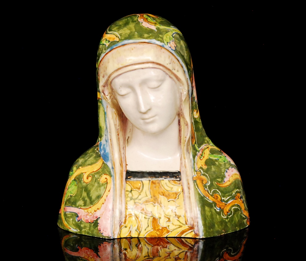 A 19th Century French handpainted majolica bust of a Madonna wearing a veil in green with pink and