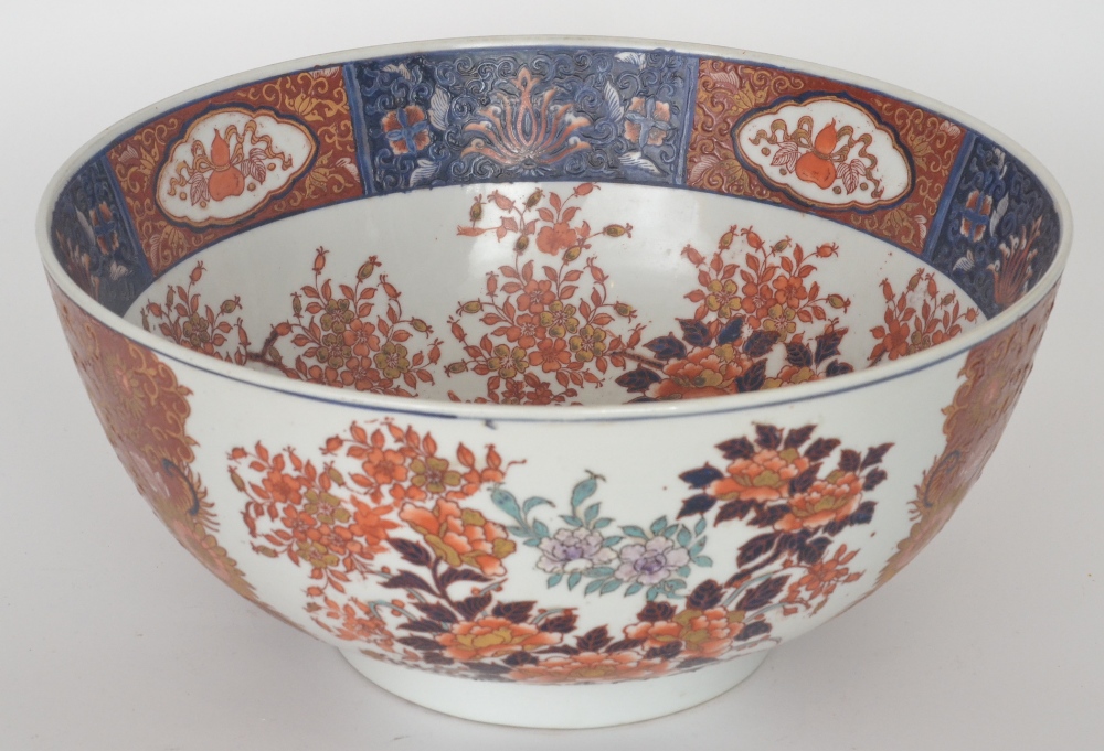 A large 20th Century Chinese export bowl, the whole decorated in the Imari palette with a spray of