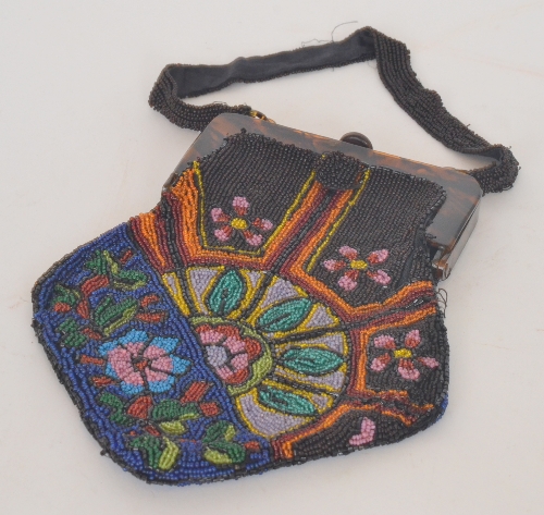 An early 20th Century bead work handbag decorated with a floral design to a blue and brown ground,