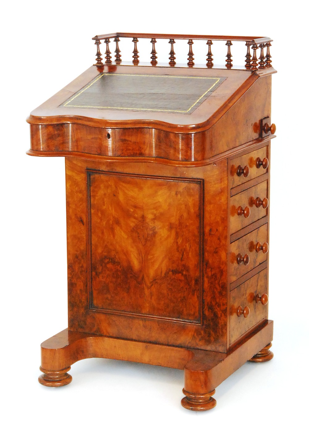 A Victorian figured walnut Davenport, the spindle turned gallery over a serpentine lift front,