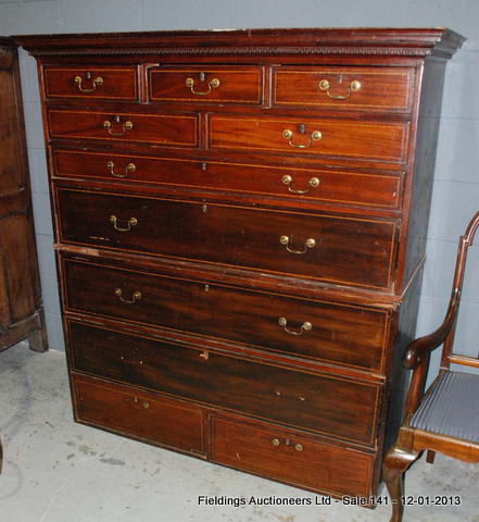 A late Georgian mahogany chest on chest with a cornice top over an arrangement of eleven drawers,