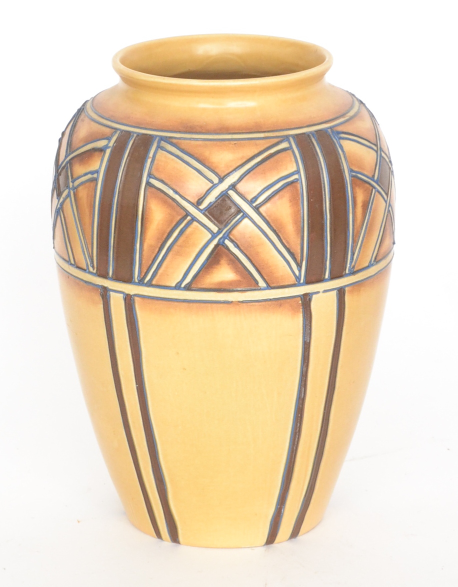 A 1930`s Royal Cauldron vase of tapering form decorated by Edith Gater with tubelined panel motifs