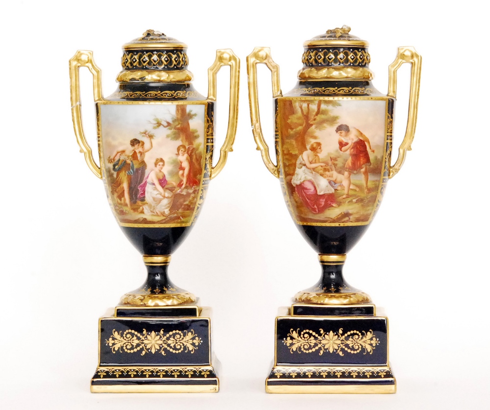 A pair of late 19th Century twin handled Berlin pedestal vase and covers each decorated with
