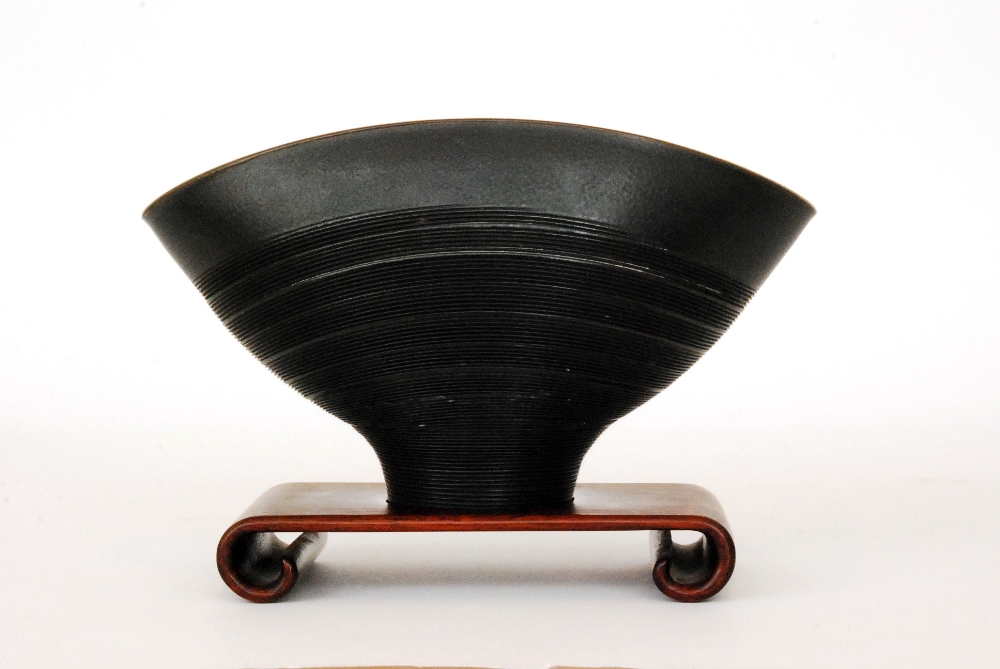 A 20th Century studio pottery elliptical bowl in an all over black glaze with linear threading