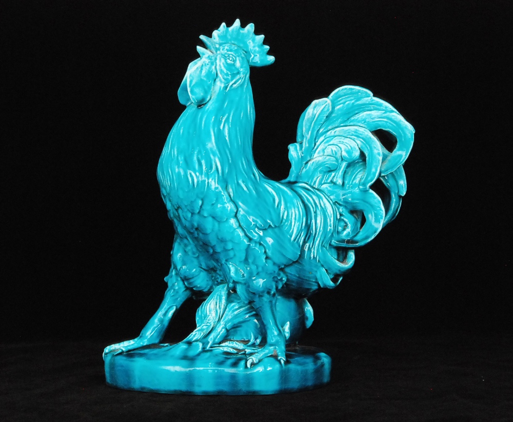 A 19th Century Clement Massier turquoise glazed majolica model of a cockerel stood before a spill