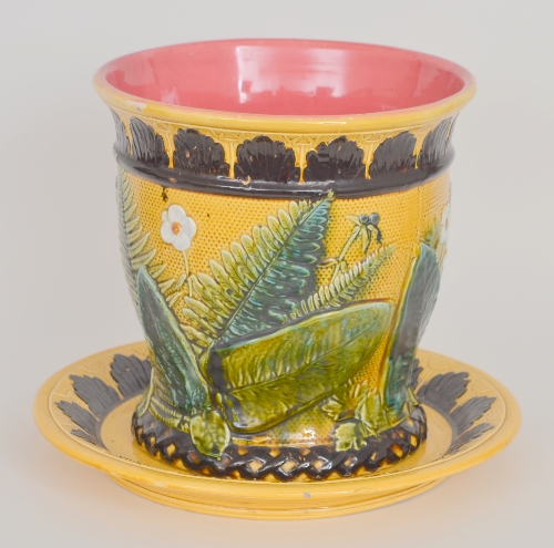 A large 19th Century French majolica jardiniere on a circular dish decorated with various ferns,