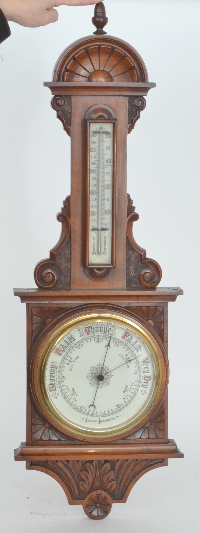 A Victorian carved oak aneroid barometer with thermometer, beehive finial, 92cm high