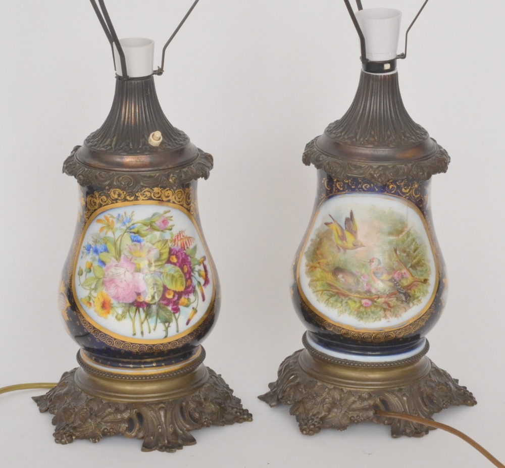 A pair of late 19th Century Continental vases of baluster form decorated with panels of hand painted