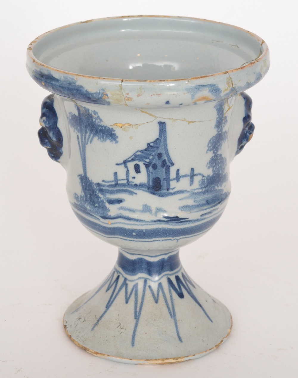 A late 19th Century Delft tin glazed urn or drug jar decorated with a blue and white church and