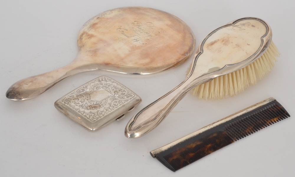 A hallmarked silver backed hand mirror, together with a silver hair brush, comb and a cigarette
