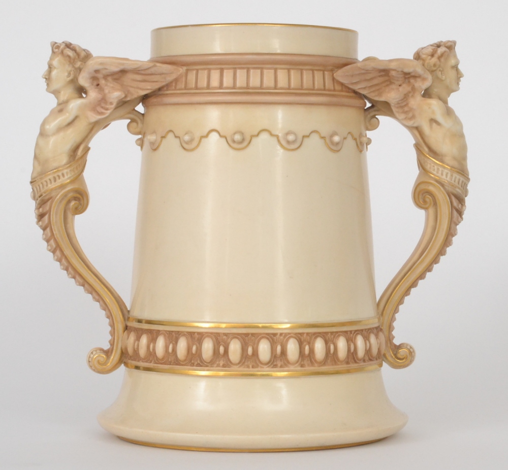 A Royal Worcester blush ivory twin handled vase, the handles formed as caryatid`s, the body with